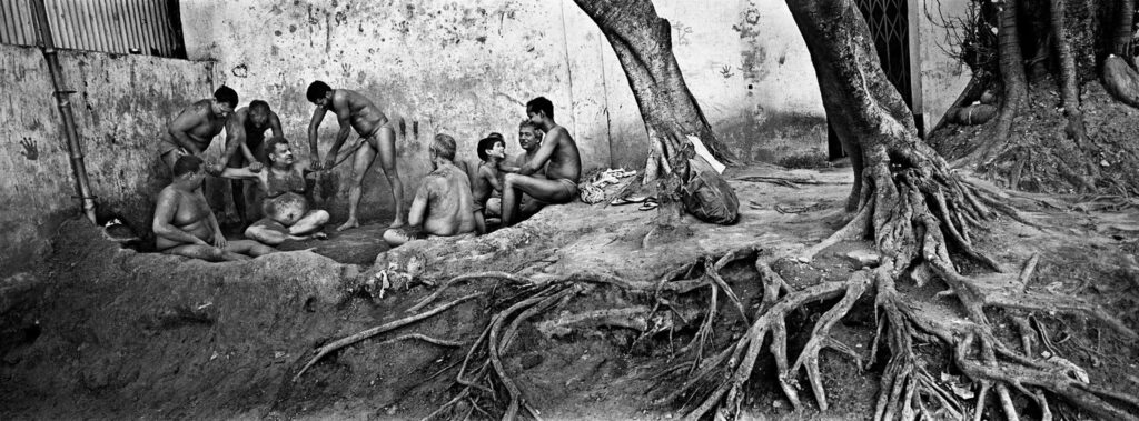 A senior wrestler get massage from his colleagues, at a wrestlers' ground under howrah bridge- Kolkata 2004