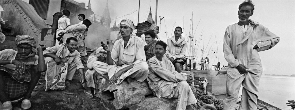 Men watching in different directions- Manikarnika Ghat- Where Hindu burns their deads. Varanasi 2005