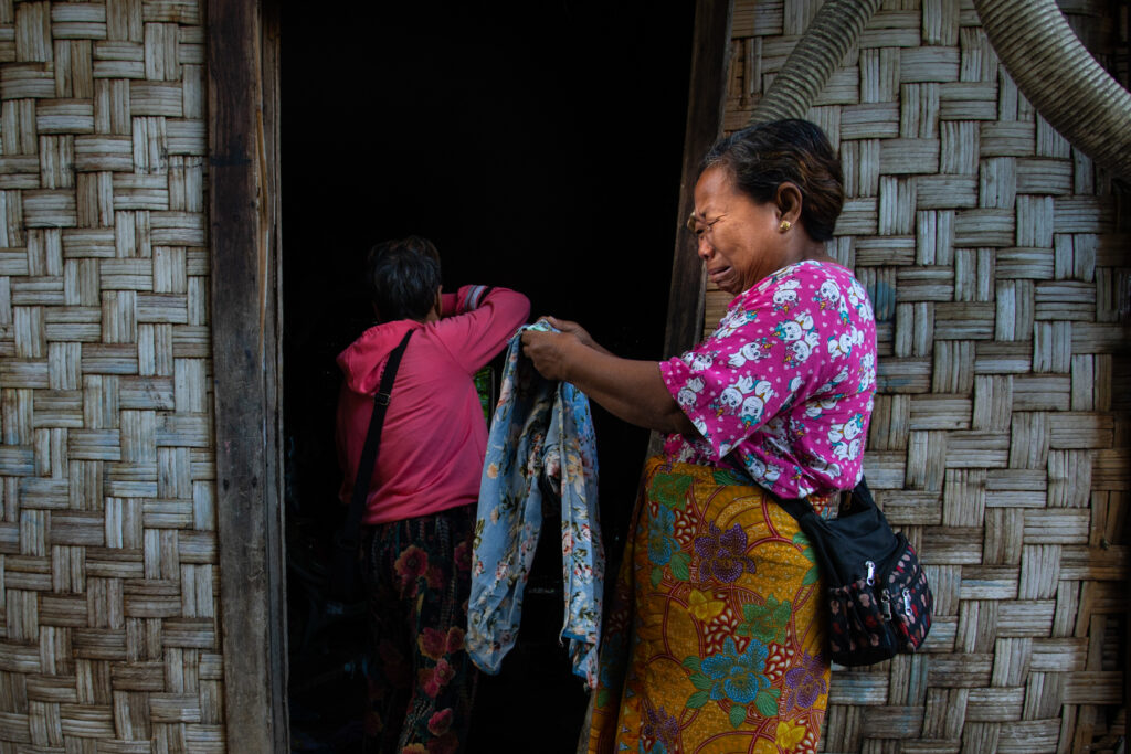 Family members mourn as their village was bombarded by the Myanmar military in onglaw Village, Momauk Township.