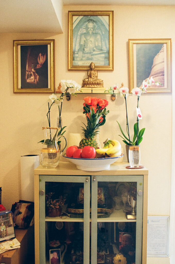 03 - Golden Buddha surrounded by
three photographs.