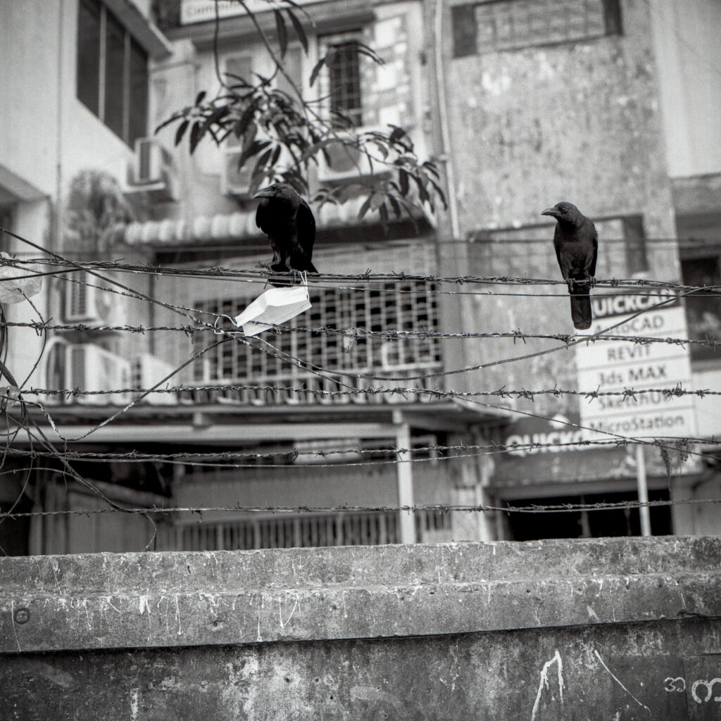 Discarded surgical mask is seen hanging on the fence of a residential building in Yangon, Myanmar on 13 April 2020. Government issues stay-at-home order as the first case of Covid-19 has been discovered in Myanmar and order citizens to wear mask to avoid airborne transmissions.