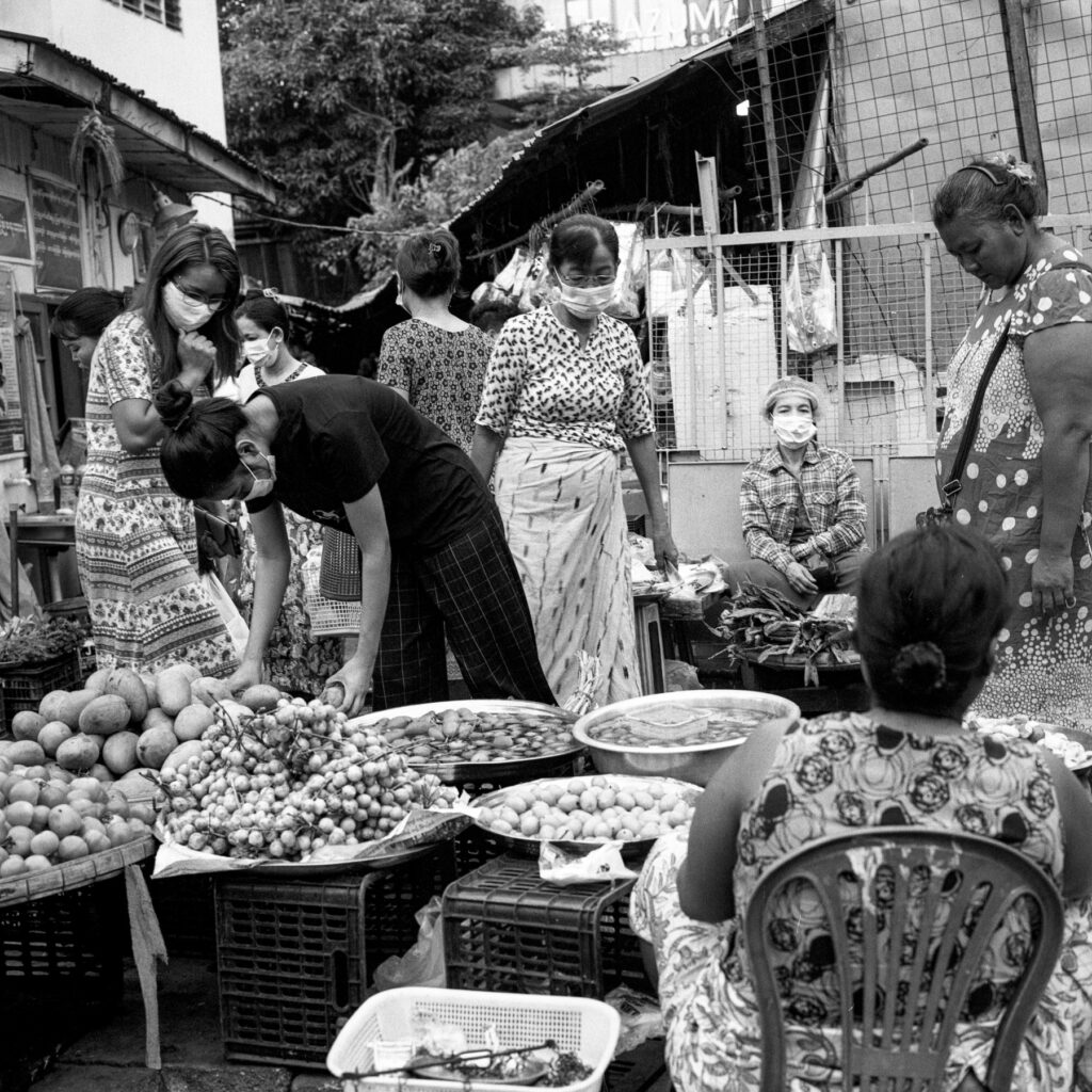 People wearing surgical masks are seen in a wet market in Yangon, Myanmar on 13 April 2020. Despite Myanmar governmetn ban public gathering more than five people, wet markets are crowded with people and risk of Covid-19 transmssion is still high.