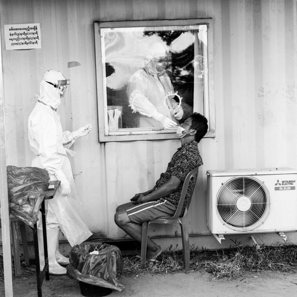 Volunteer medical workers collecting nasal swab from a lorry driver at the highway road in Yangon on 17 October 2020.