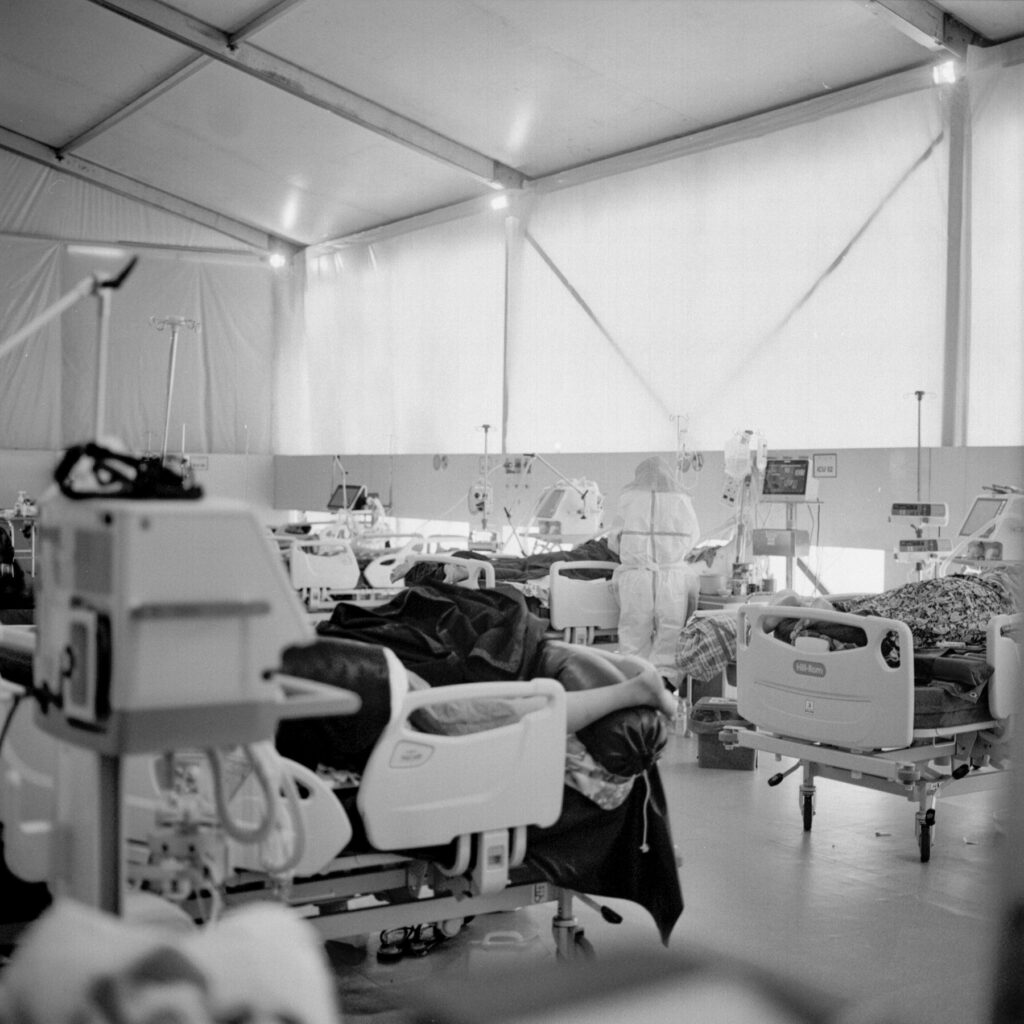 A volunteer medical workers examining a Covid-19 patient in ICU unit of AYA Covid-19 treatment center in Yangon on 12 November 2020.