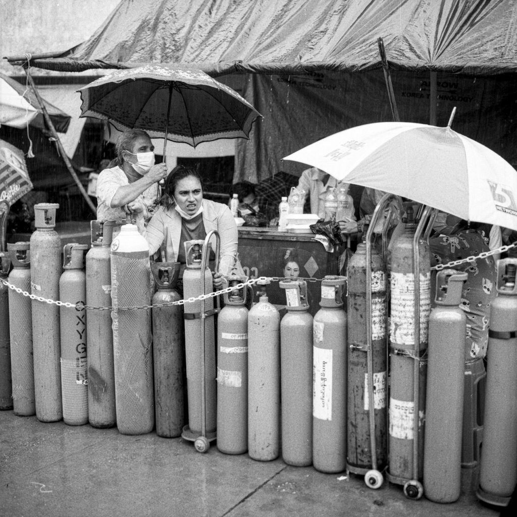 People line up to refill oxygen cylinders at Nwe Aye mosque where volunteers refill oxygen for free during Covid-19 third wave surges in Yangon on 12 July 2021. As Myanmar military seizes power from the democracy government,  country's healthcare system collapsed and thousands of people died by the Covid-19 symptons around the country.