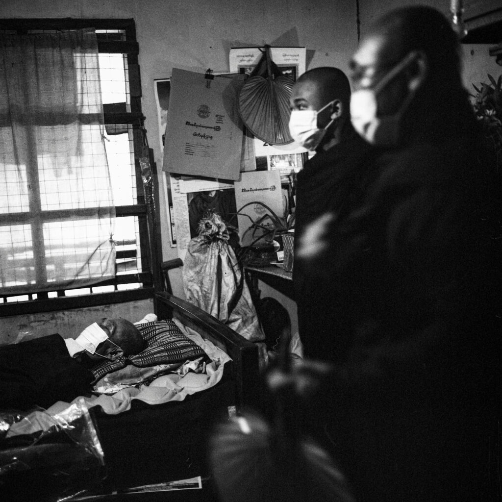 Deceased body of a Buddhist monk who died from Covid-19 symptons is seen inside a residential building in Yangon on 22 July 2021.