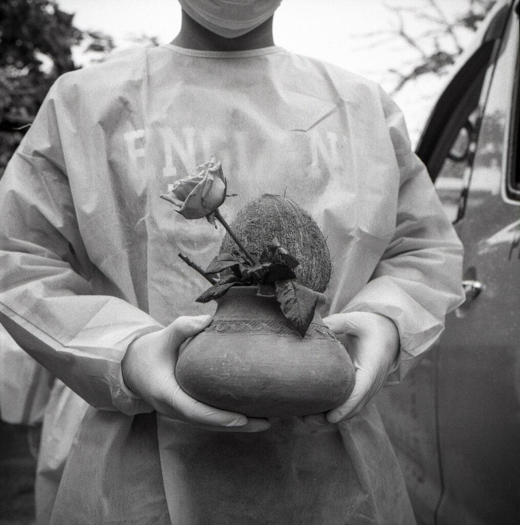 Family member of a deceased man who died from Covid-19 symptoms, carry a pot with flower and coconut as traditional ritual processing at cemetary in Kyisu cemetery on 23 July 2021.