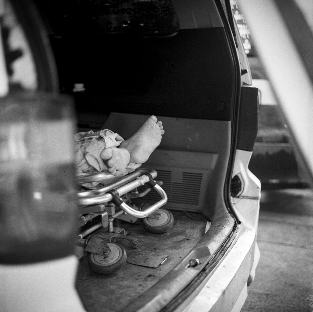 A body of a man who died with Covid-19 symptoms is seen inside an ambulance at Yayway cemetery on 22 July 2021. Hundreds of ambulances carrying dead bodies died from Covid-19 symptoms have to wait for hours to drop off dead bodies at cemetery during the Covid-19 third wave in Myanmar.
