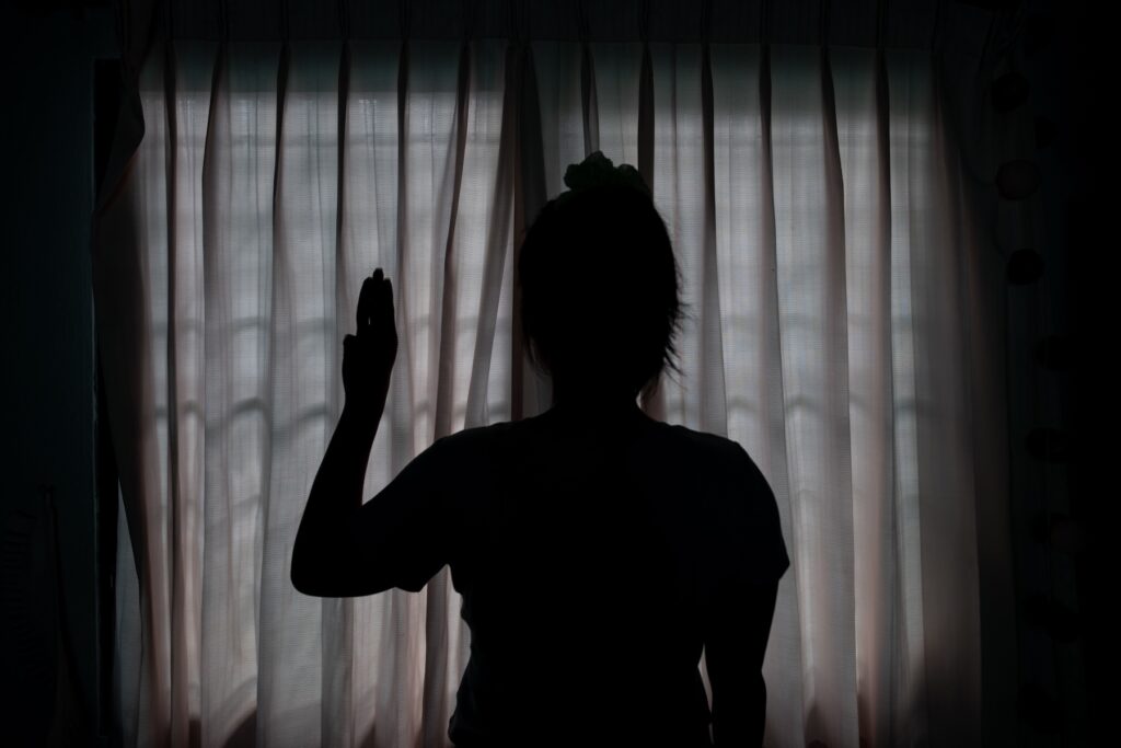 Women's rights activist Aureena poses for a photograph with the three-finger salute at her home in Chiang Mai, Thailand, on October 5, 2025.