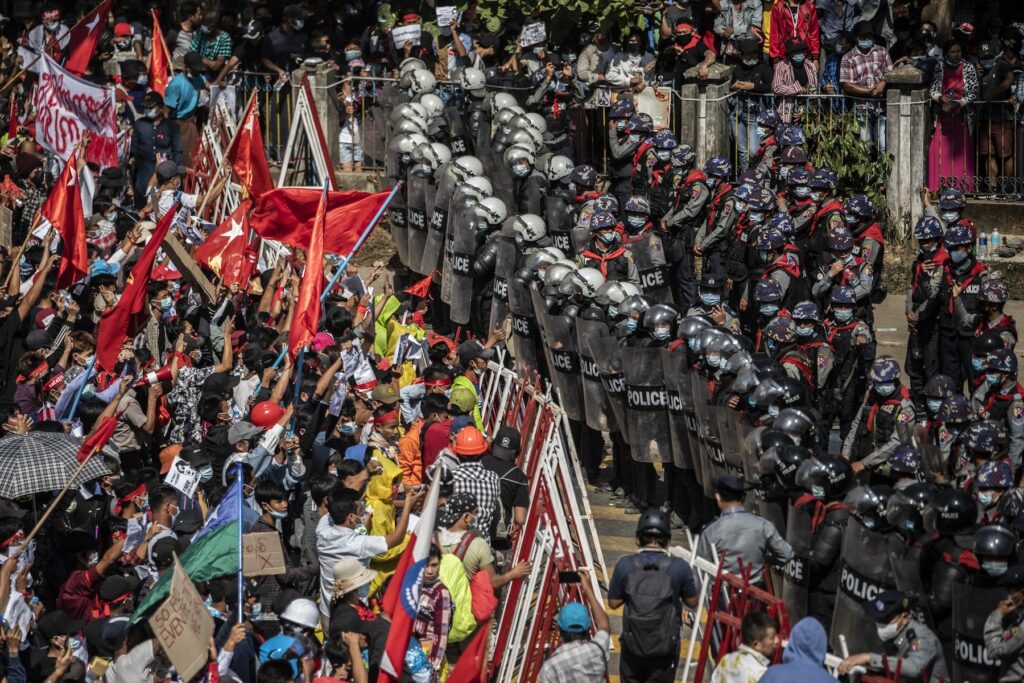Protesters interact with polices during a protest against the military coup in Yangon, Myanmar, 9 February 2021.