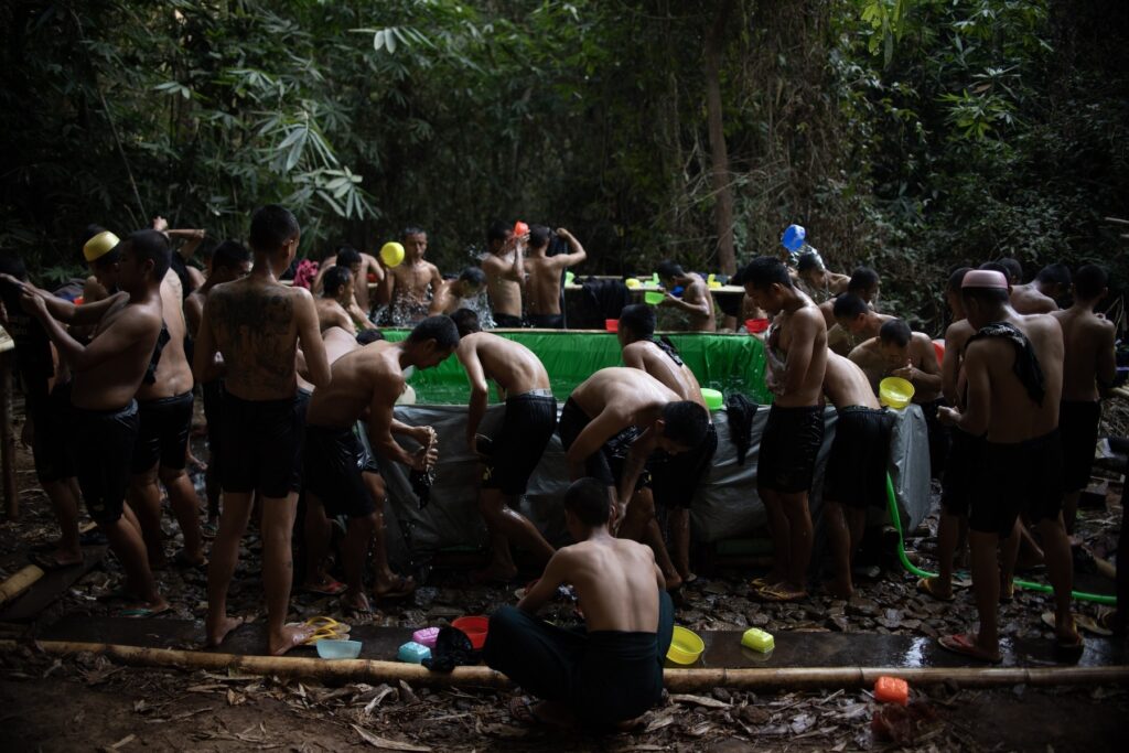 Nwely recruit of Bamar People's Liberation Army (BPLA) take shower during their break in undislosed location in Myanmar on February 19, 2024.