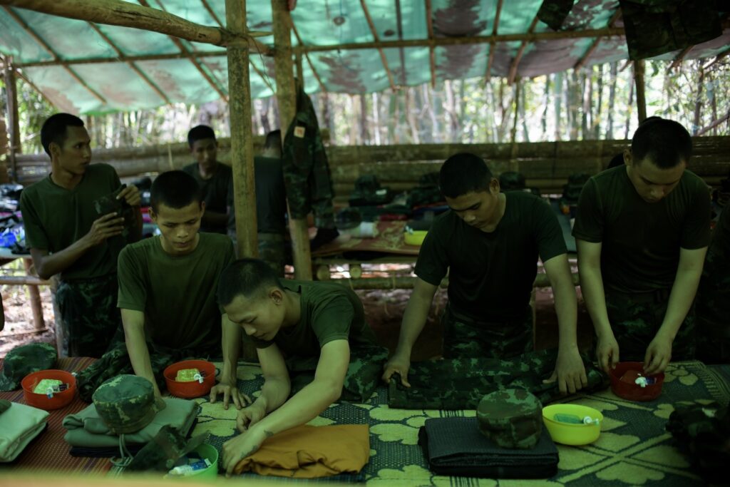 New recruits of Bamar People’s Liberation Army (BPLA) fold their clothes during a break time at a camp in Karen State, Myanmar, March 5, 2024.