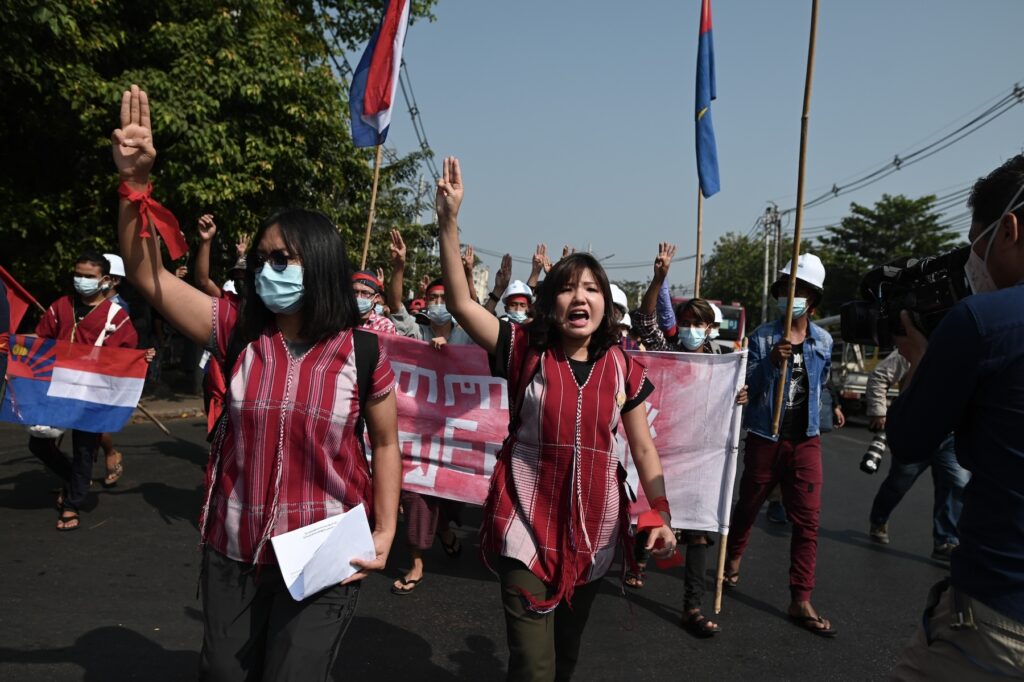 Activists Ei Thizar Maung and Ester Ze Naw flash a three-finger salute during a protest against the military coup in Yangon, Myanmar, on February 6,  2021.